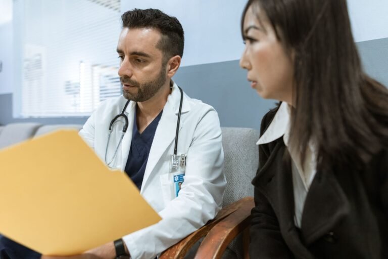 Doctor in Pakistan talking to a patient during a clinic consultation